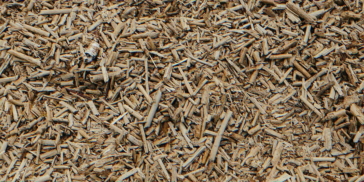Pile of fresh hardwood bulk mulch ready for spring garden delivery inspection